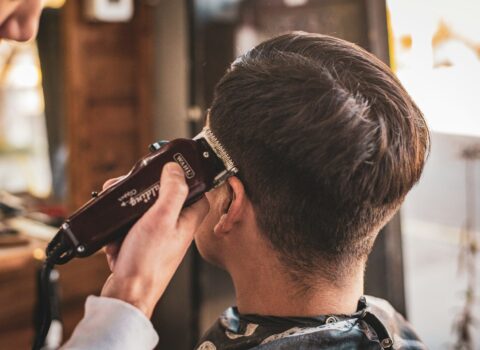 man in white dress shirt holding black dslr camera